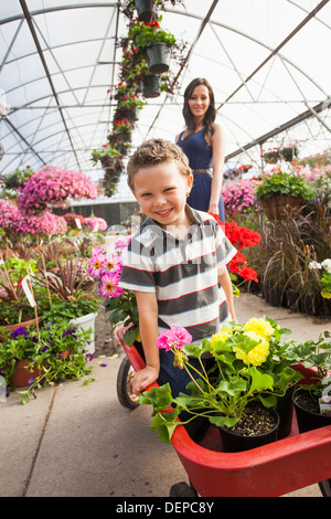 Caucasian mother and son shopping in plant nursery