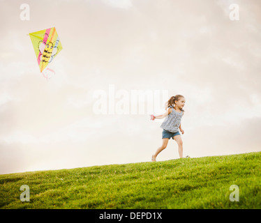 Caucasian girl flying kite Stock Photo