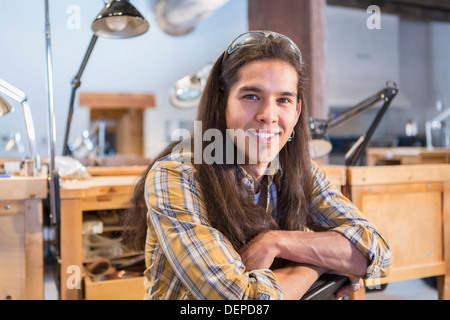 Mixed race man smiling in art studio Stock Photo