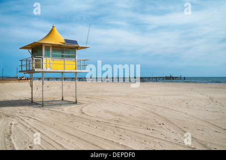 Lifeguards watch out from a surf life saving tower on an Australian beach in Glenelg, Adelaide. Stock Photo