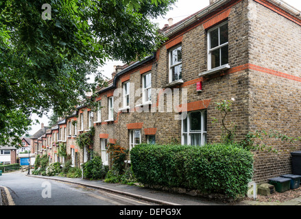 A sloping side street of traditional Victorian, brick built, two storey terraced houses, in Crystal Palace, London, England, UK. Stock Photo