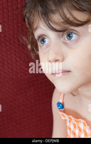 Surprised little girl looking away Stock Photo