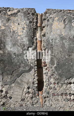 Sewer pipes set in a wall in a house in Pompeii leading from the first floor to the ground Stock Photo