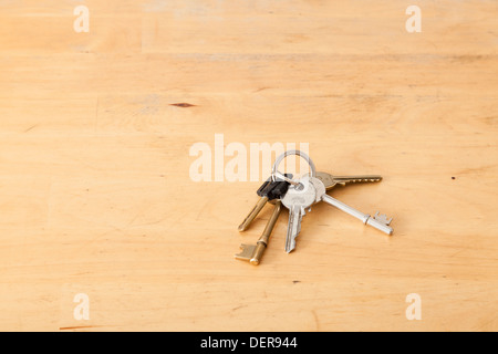 Small bunch of keys on a key ring left on a table Stock Photo