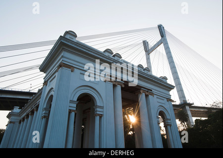 Low angle view of a memorial with bridge in the background, Prinsep Ghat, Kolkata, West Bengal, India Stock Photo