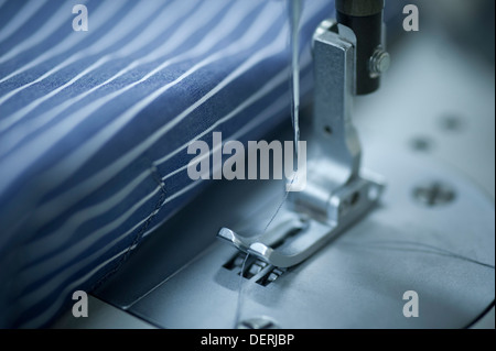 Cloth being stitched on the sewing machine Stock Photo