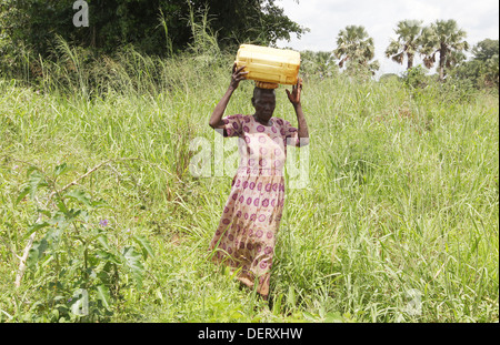 A village woman collects water in rural area of the Lira district in northern Uganda. Stock Photo