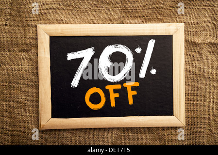 Seventy percent off, discount tag on blackboard. Stock Photo