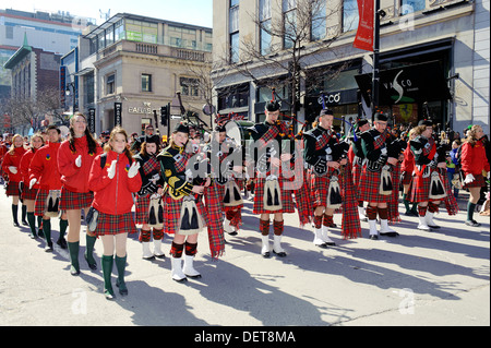 Highland dancers and Scottish marching band parading on Ste Catherine street in Montreal during the St Patrick's Day parade. Stock Photo