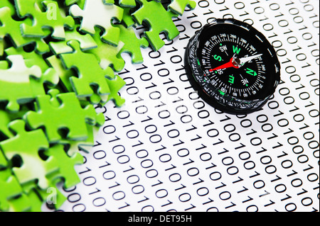 puzzles and compass on a binary code Stock Photo