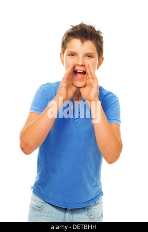 Portrait of happy young boy shouting holding hands near mouth Stock Photo