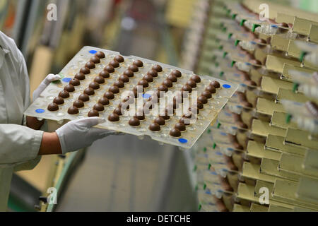 An employee of Stollwerk (GmbH) presents a palette of Christmas chocolate balls in Saalfeld, Germany, 18 September 2013. Thuringian chocolate manufacturers are in the middle of preprarations for the Christmas season. For some, it is the the most profitable time of the year. Photo: Marc Tirl Stock Photo