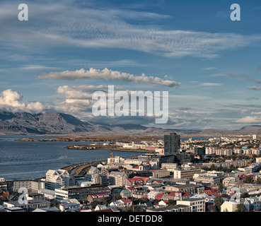 High view of Reykjavik Iceland skyline harbor harbour and mountains from above with blue sky and cumulus clouds