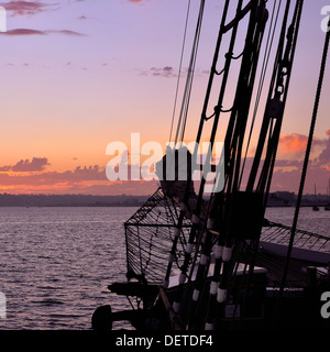 Blue hour after sunset seen through rigging of tall ship Californian in silhouette moored at Embarcadero San Diego California Stock Photo