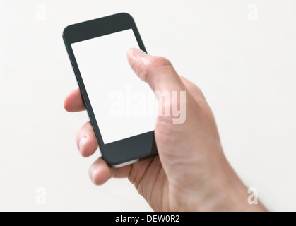Male hand holding and touching on mobile smartphone with blank screen. Isolated on white background.