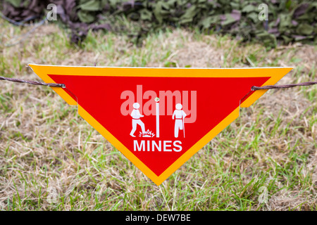 Land mine or minefield danger warning sign in a war zone area Stock Photo