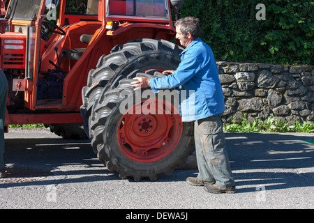 farmer farm labourer laborer repairing tractor Stock Photo