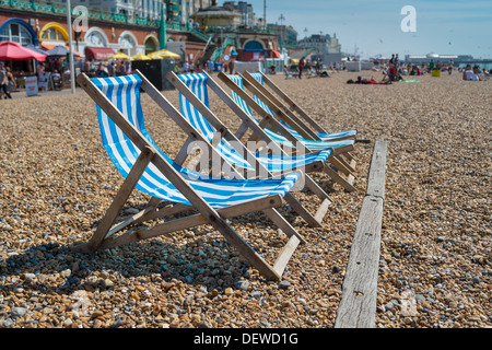 4 blue deck chairs on Brightons pebble beach Stock Photo