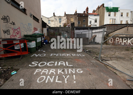 Car Parking and Social Parking comments painted onto a road in the Montpelier area of Bristol. Stock Photo