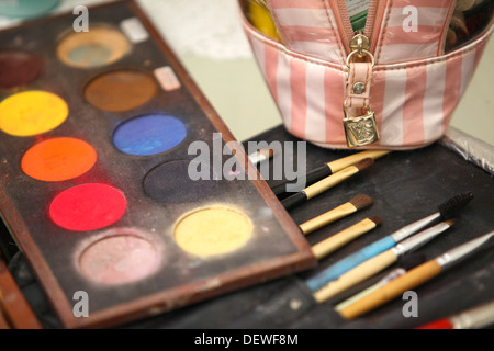 Make-up artist's bag with a variety of make-up brushes and colours  Stock Photo