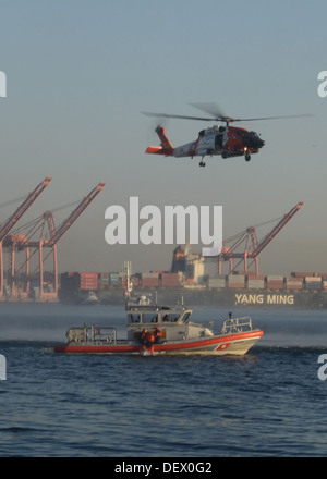 Air and boatcrews from Air Station Astoria, Ore., and Station Seattle hold a search-and-rescue demonstration in Elliot Bay near Stock Photo