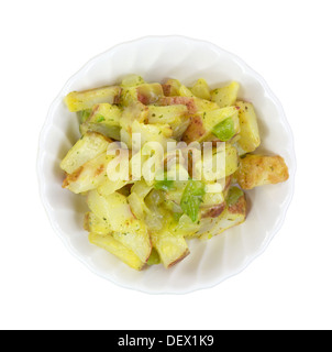 Top view of a serving of red potatoes, onions and green peppers in a small white bowl. Stock Photo