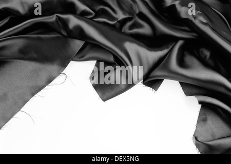 Closeup of rippled black silk fabric on plain background Stock Photo