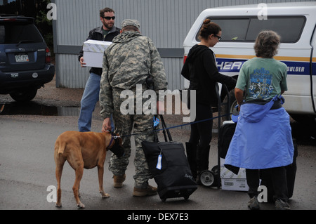 Colorado National Guardsmen assist Boulder County authorities transport evacuated residents of Lyons, Colo., to Longmont, Colo. Stock Photo