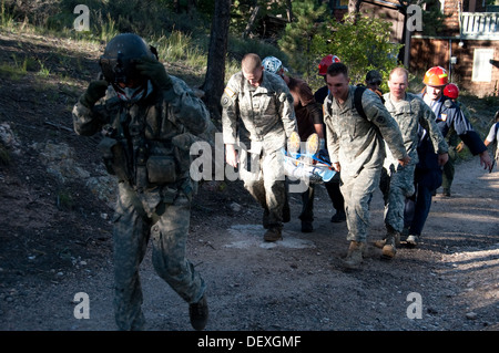 Civilian rescue personnel and members of the Colorado Army National Guard 3rd Battalion 157th Field Artillery Alpha Battery use Stock Photo