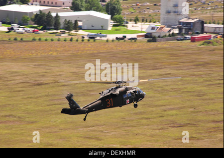 A U.S Army UH-60 Blackhawk helicopter assigned to Charlie Company, 5th Battalion, 159th Aviation Regiment, Wyoming National Guard, returns to Christman Field west of Fort Collins Colo. Sept. 17, 2013. What is being dubbed “Operation Centennial Raging Wate Stock Photo