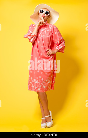 studio vintage fashion full length portrait of a female model wearing 60s vintage dress Stock Photo