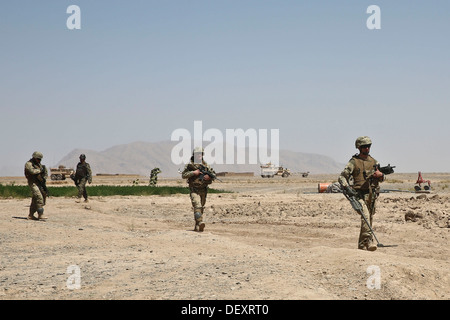 Afghan National Army (ANA) soldiers and Coalition Forces patrol in Barrmo, Washir district, Afghanistan, Sept. 19, 2013. The ANA and Coalition Forces conducted mounted and dismounted patrolling and engaged local nationals to prevent insurgency. Stock Photo