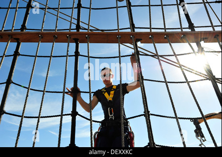 Coast Guard Barque Eagle crew member Seaman Joel Sprowls climbs down the rigging after furling sails aboard EAGLE on Wednesday, Stock Photo