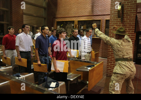 Sgt. Jonathan Brooks, a drill instructor, rushes new recruits of Lima Company, 3rd Recruit Training Battalion, to desks shortly Stock Photo