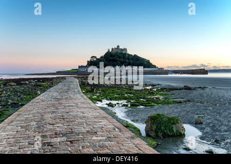 The sea causeway at low tide leading to St Michael's Mount a small isle off Marazion near Penzance in Cornwall Stock Photo