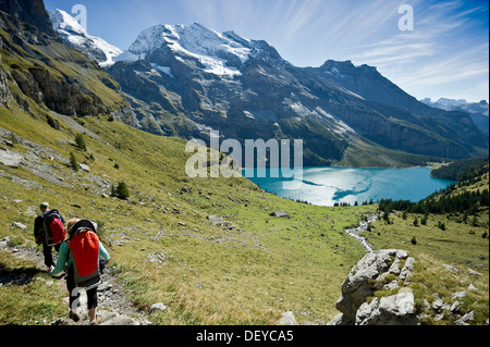 Hikers at Oeschinensee, Oeschinen Lake, Bernese Oberland, Canton of Bern, Switzerland, Europe Stock Photo