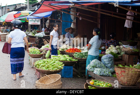 A woman sells vegetables in a market in Hpa-An, Burma. Stock Photo