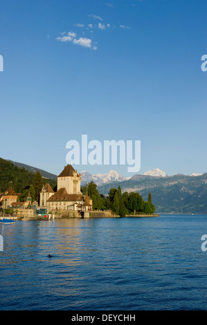 Schloss Oberhofen castle on Lake Thun, Bernese Oberland with the mountains Moench, Eiger and Jungfrau at back, Bernese Oberland Stock Photo