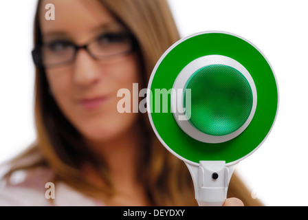 Woman holding a signalling disk, green light Stock Photo