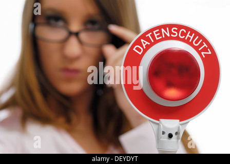 Woman holding a red police signalling disk, Datenschutz, data protection, written on it Stock Photo
