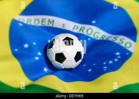 Football on Brazilian flag, football world championship in 2014 in Brazil, Stock Photo