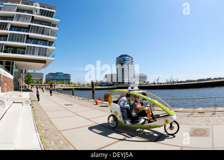 Bicycle taxi on the Dalmannkai Promenade, Hafencity, Hamburg Stock Photo
