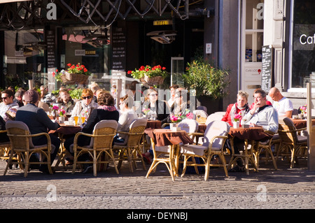 Customers sit outside Hotel de la Bourse restaurant cafe bar pub on Markt Maastricht Netherlands Stock Photo