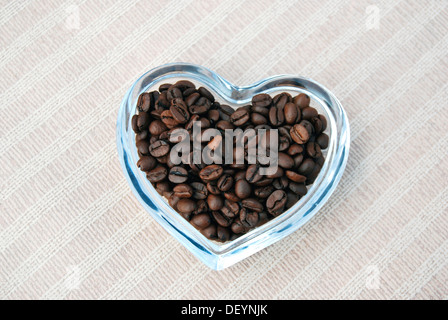 Coffee beans in a heart-shaped glass bowl Stock Photo