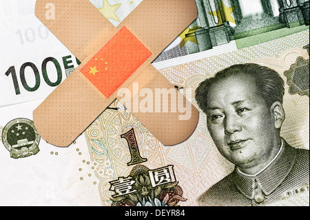 Banknotes, Chinese yuan and a 100 euro note with sticking plasters, symbolic image, China offered help for the euro Stock Photo