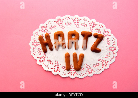 Lettering 'Hartz IV', name of the German unemployment benefit, alphabet biscuits on a cake lace coaster Stock Photo