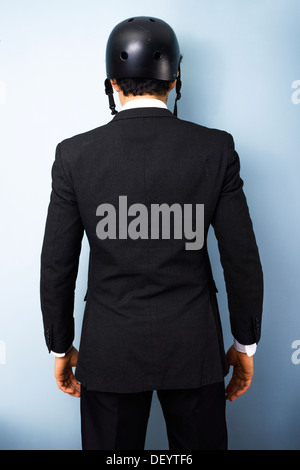 Rear view of business man with a BMX helmet Stock Photo