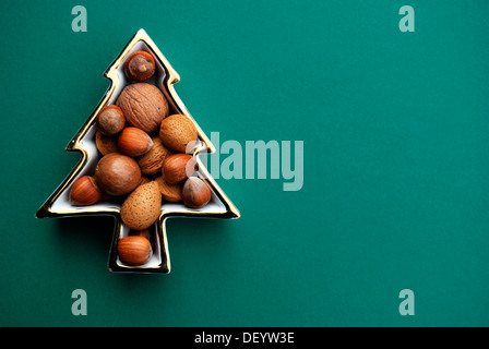 Various nuts in a tree-shaped bowl Stock Photo