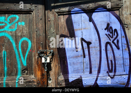 Graffiti on a Old Door on the Quayside by the River Po Turin Piedmont Italy Stock Photo