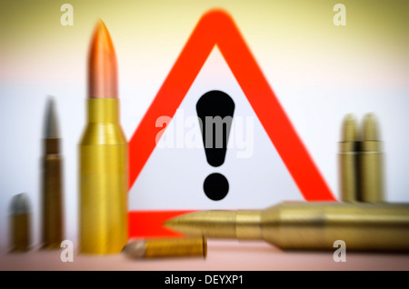 Cartridges before danger sign, terror warning, Patronen vor Gefahrenschild, Terrorwarnung Stock Photo